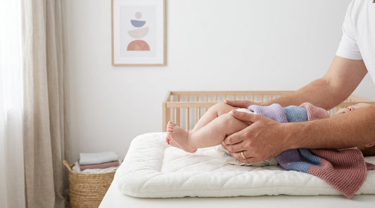 how to hold baby's legs when changing diaper?